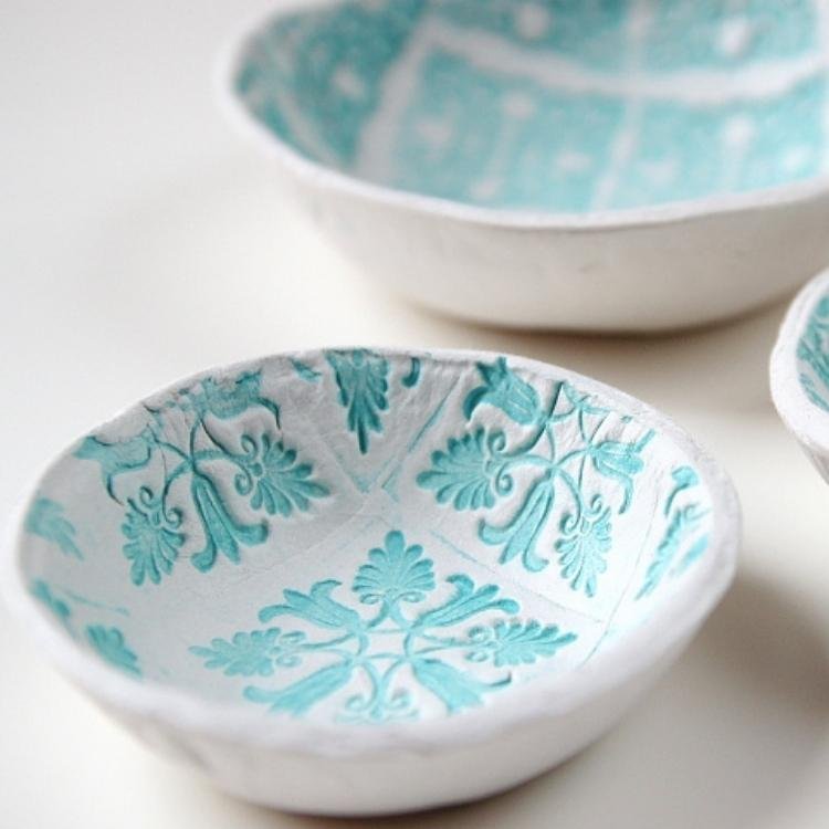 air dried clay bowls with blue repeating pattern stamped on the inside