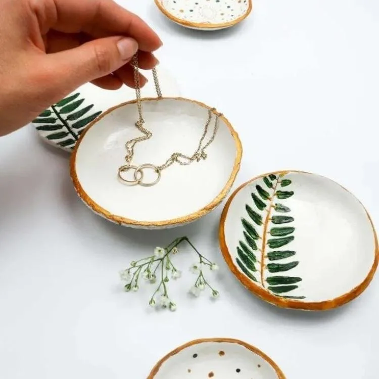 clay bowls painted with green ferns and gold rim