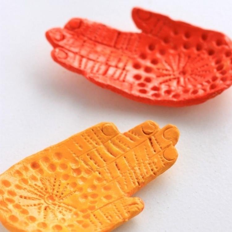 painted orange and yellow air dry clay hands