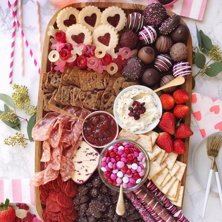 valentines day charcuterie board with cheese, meat and chocolate