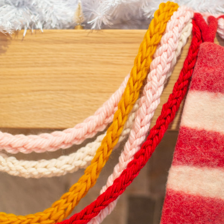 garland made from finger knitting hanging from fireplace