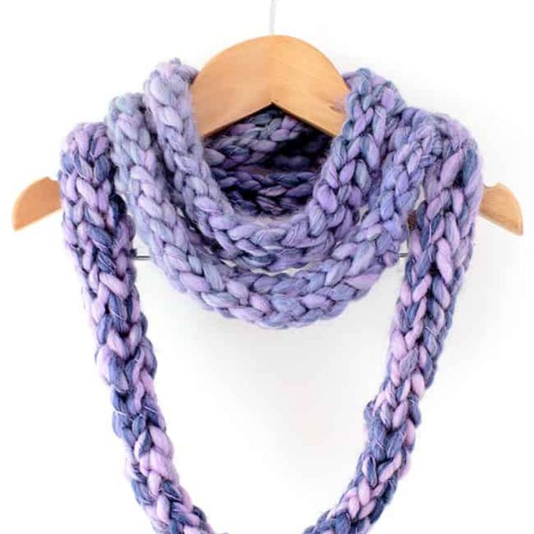 purple finger knit infinity scarf hanging from clothes hanger