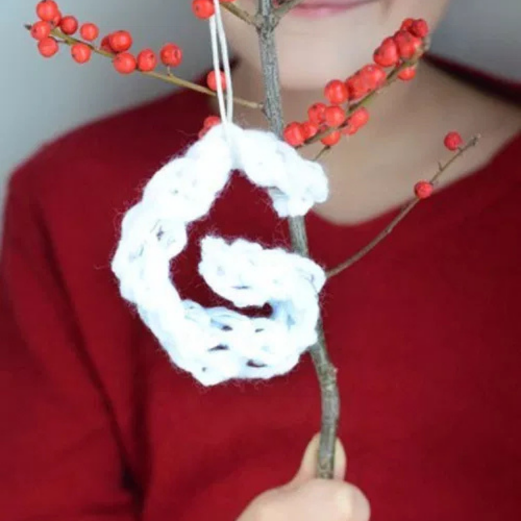 knitted 'G' hanging from branch