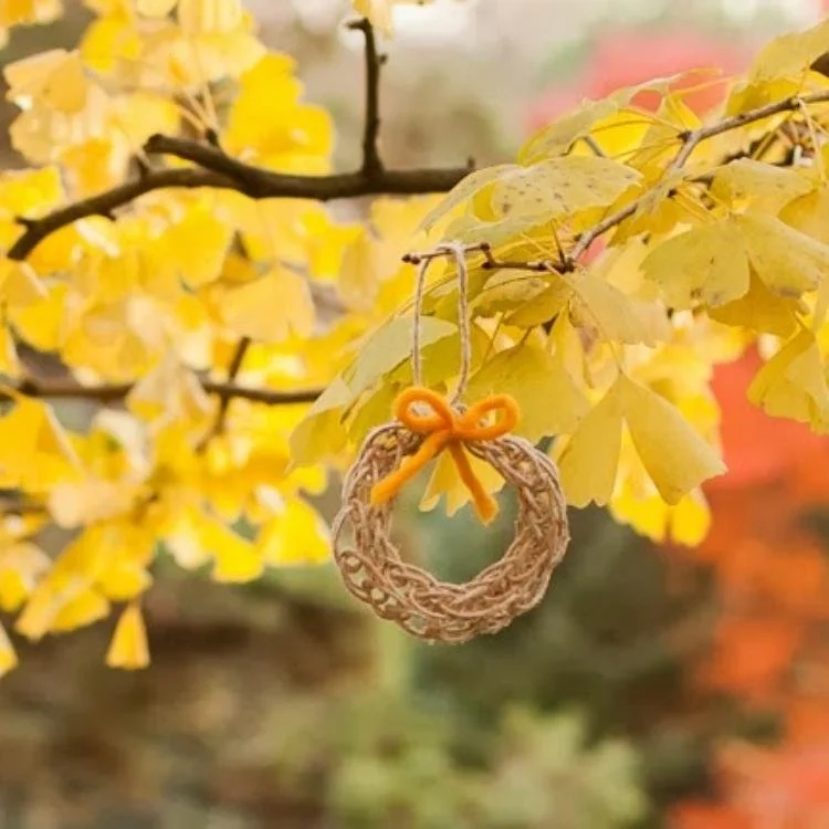 mini wreath hanging from tree branch