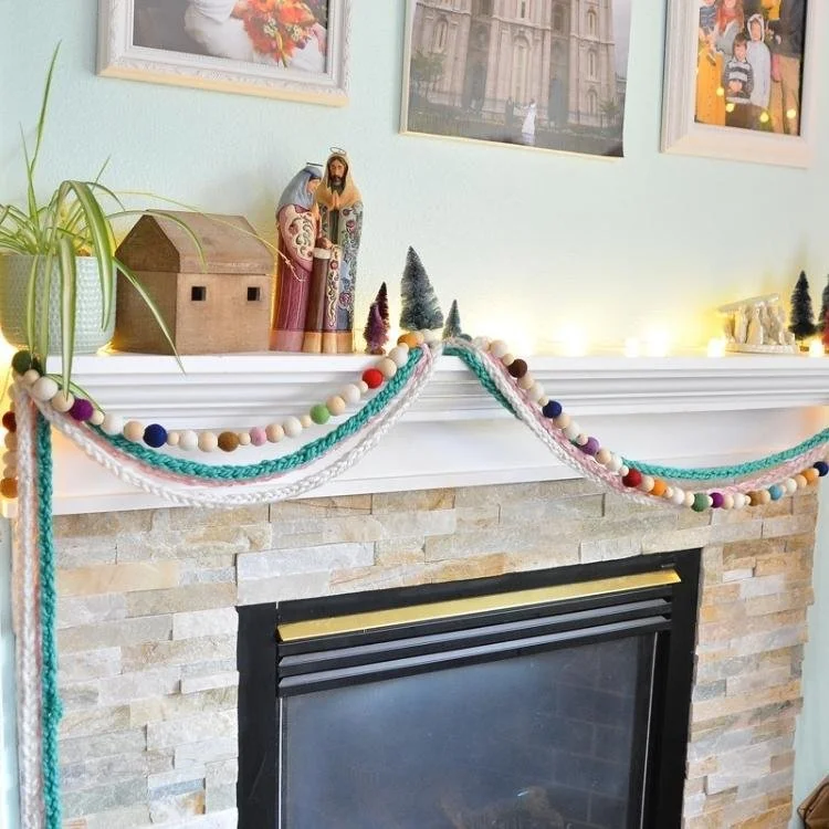 knitted garland hanging from fireplace