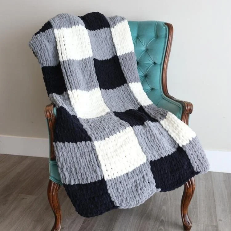 black and white checked blanket draped on chair