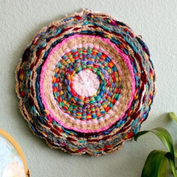 circular woven rug hanging on wall