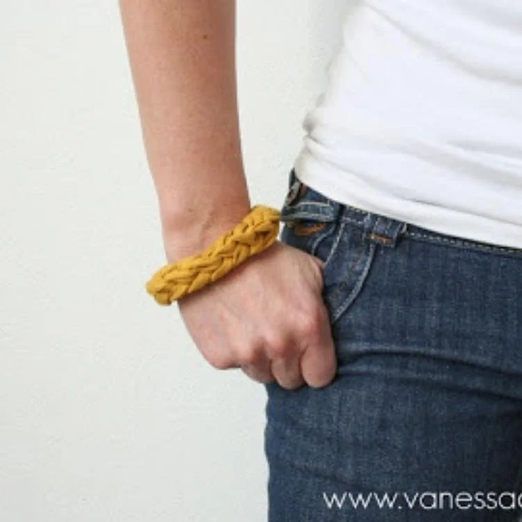 person with hand in pocket wearing yellow chunky bracelet on wrist