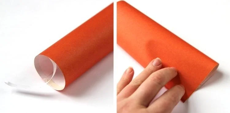 orange paper tube pressed flat at one end