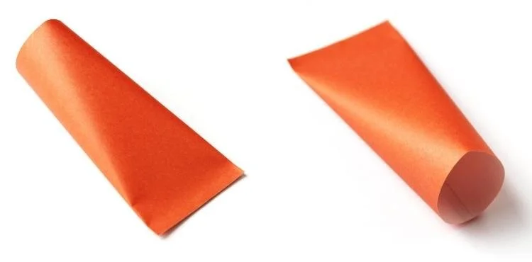 orange tube pressed closed at one end and open at the opposite end.