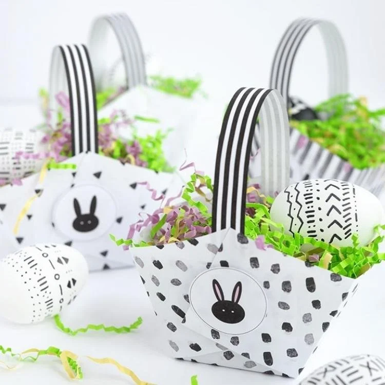 Black and white paper Easter baskets filled with shredded paper.