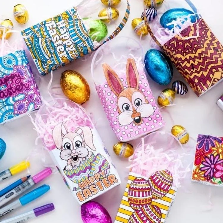 Printable Easter treat bags surrounded by eggs and felt tips.