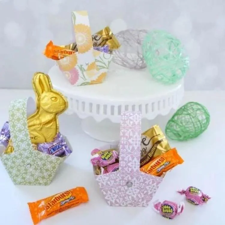 Three patterned Easter baskets surrounded by candy.