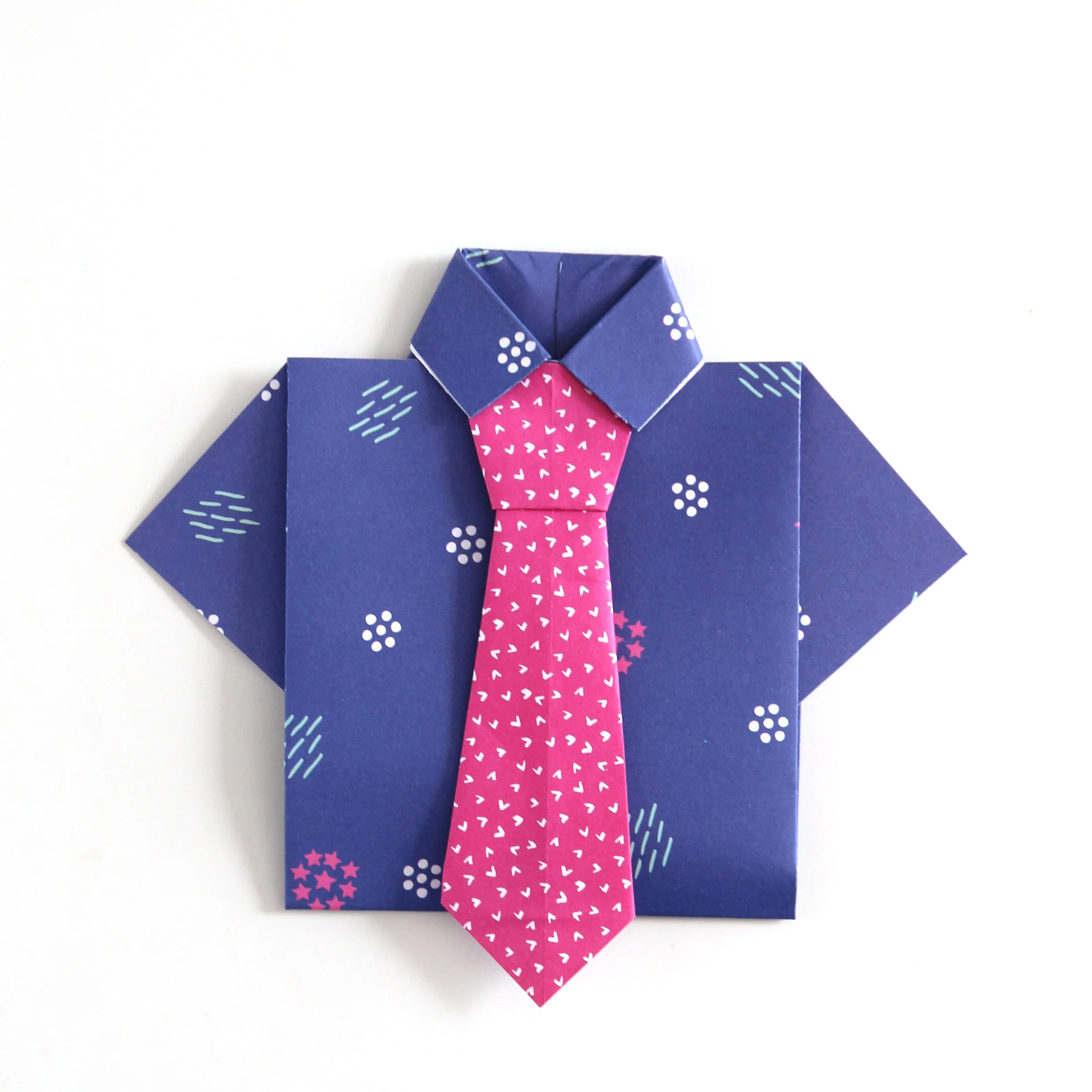 Blue origami shirt with pink origami tie.