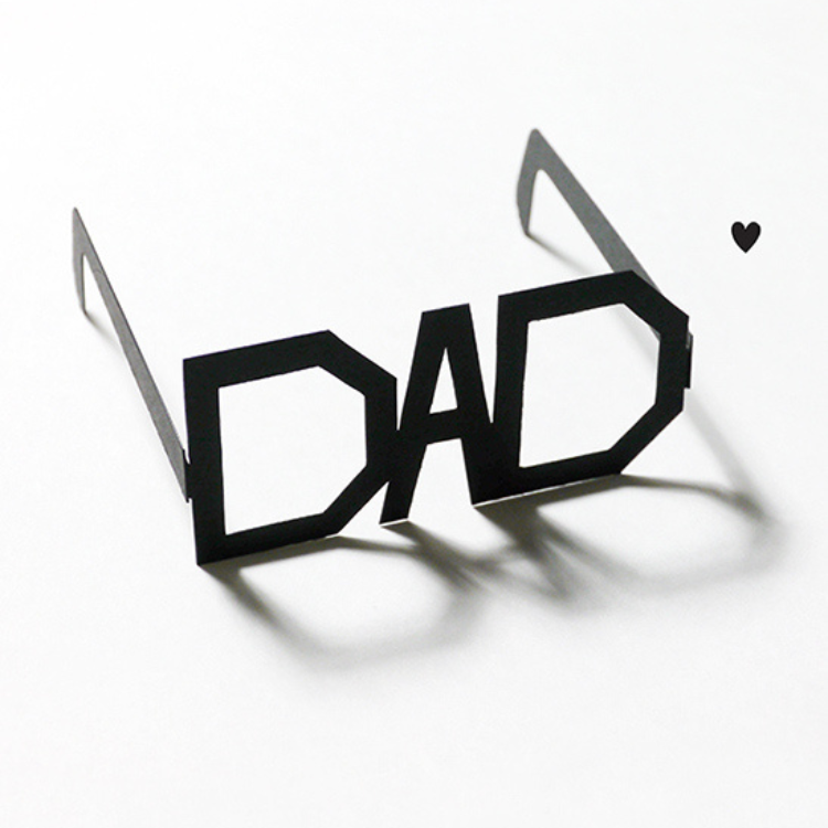 Black paper glasses in the shape of the word 'dad'.