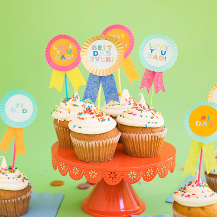 Cupcakes on cupcake stand with best dad ever rosettes on top of each cupcake.