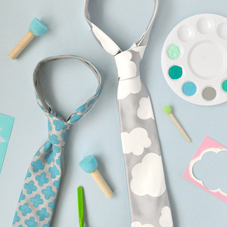 Grey tie with white clouds painted on.