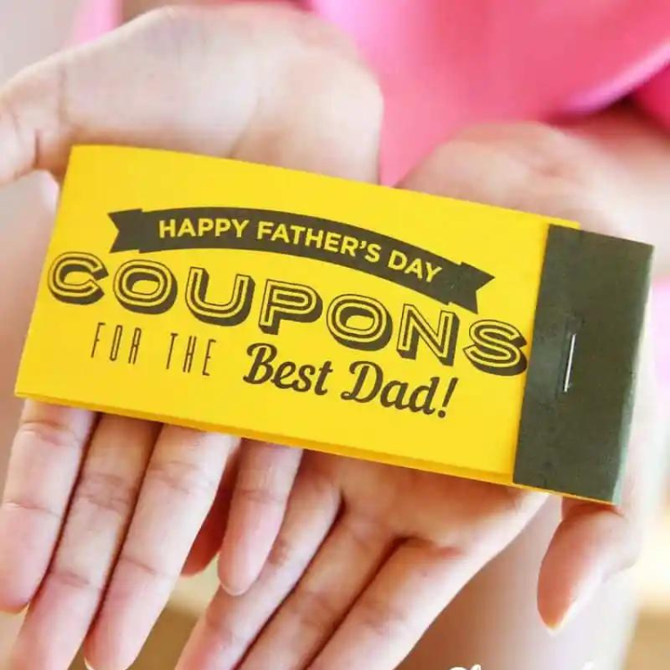 Hands holding fathers day coupon book.