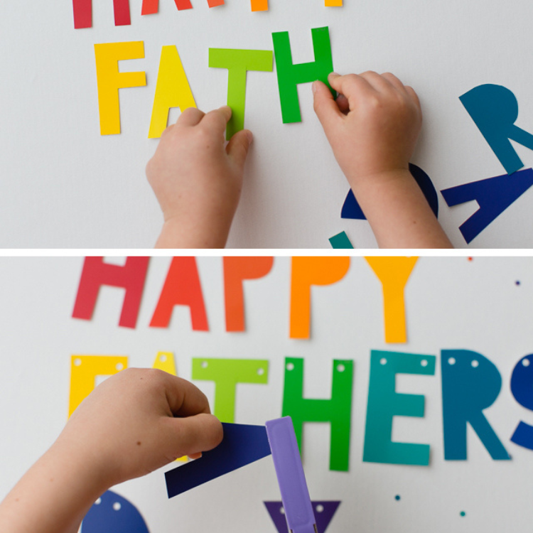 Paper letters with holes being punched in them.