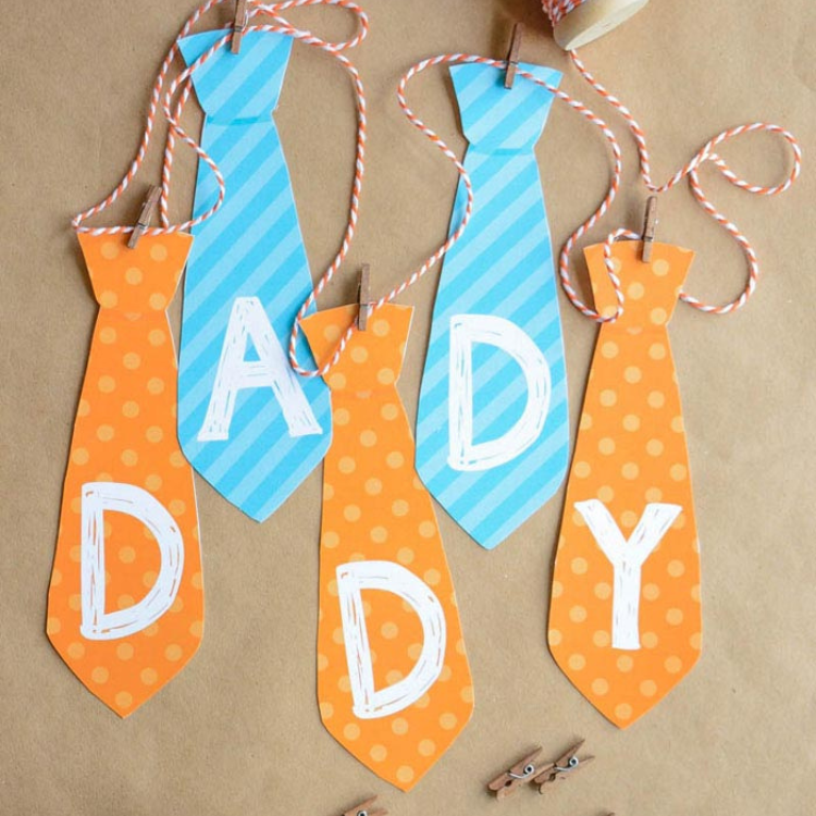 Orange and blue ties spelling the word daddy.