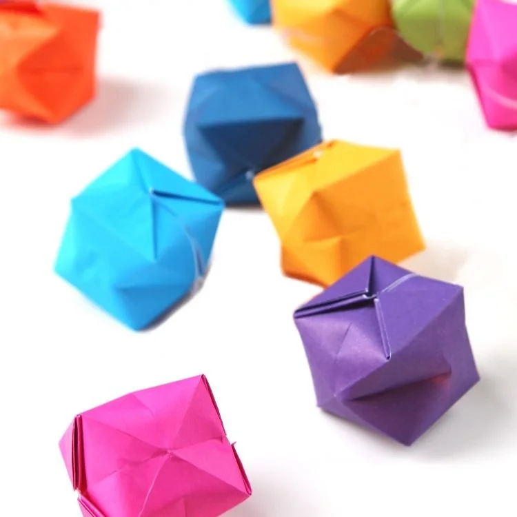 Origami paper waterbombs on white background.
