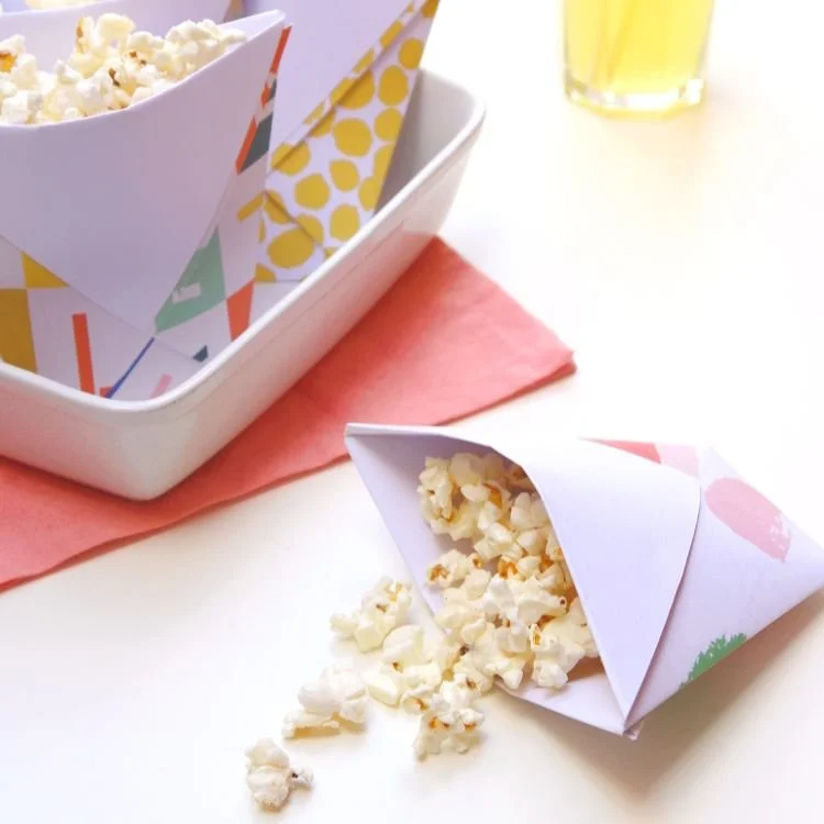 Origami snack cup filled with popcorn.