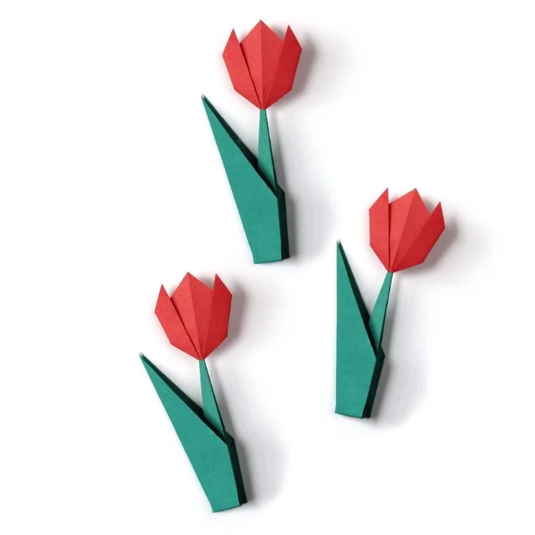 Origami tulips with red flower head and green stems.