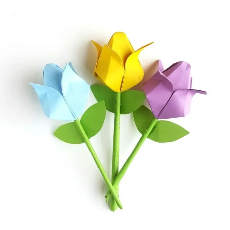 Three origami tulips on stems.