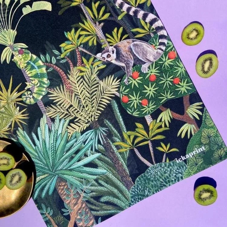 Black tea towel with lemur jungle pattern.