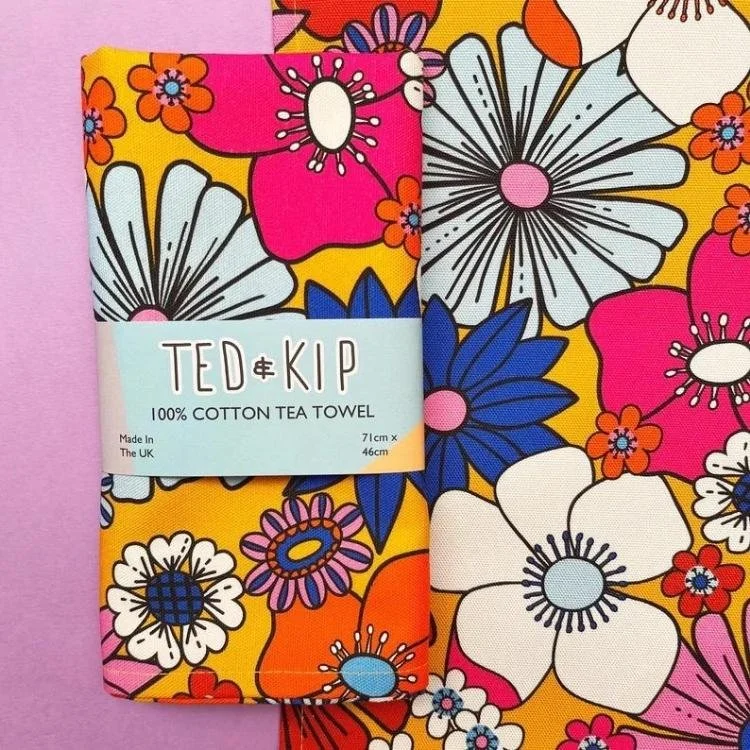 Mustard yellow tea covered in retro style flowers.