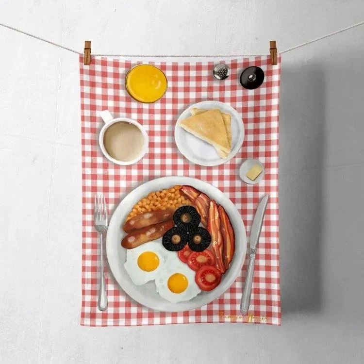 Red and white checked tea towel with full English breakfast design printed on it.