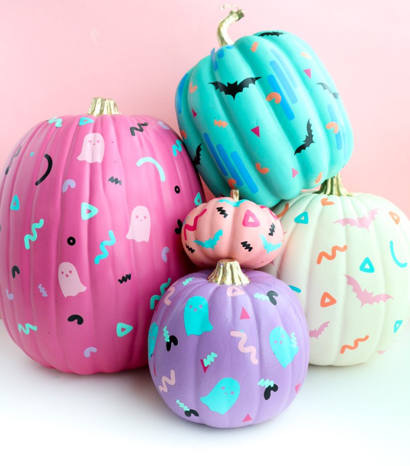 Pastel pumpkins decorated with ghosts and bats.