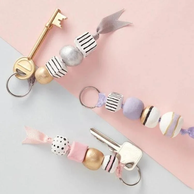 Beaded keychains on pink and grey background