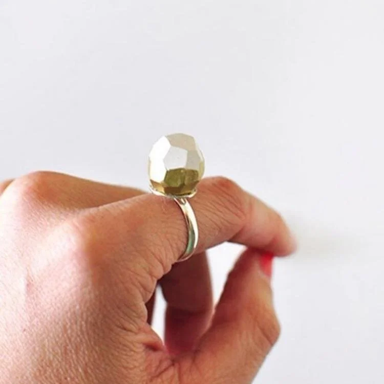 Close up of geometric ring on hand.
