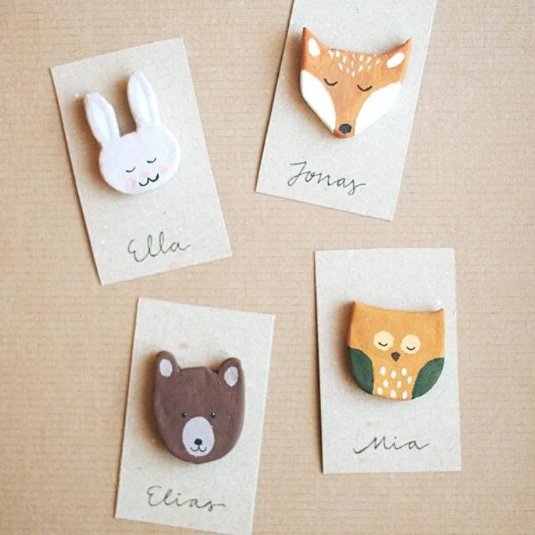 Four animal shaped painted badges.