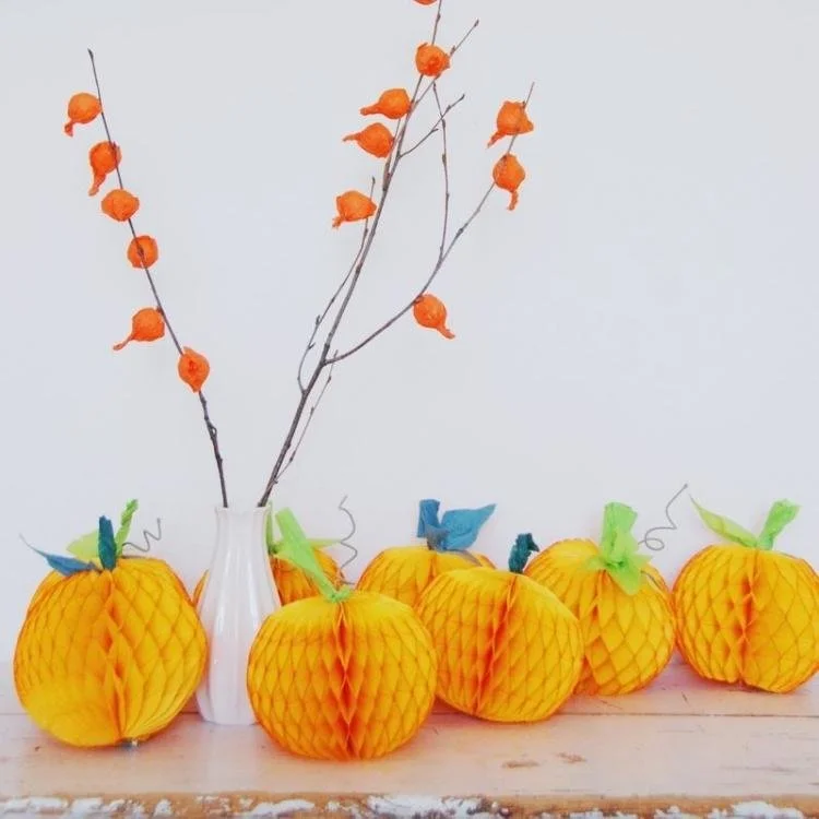 Orange honeycomb paper pumpkins.