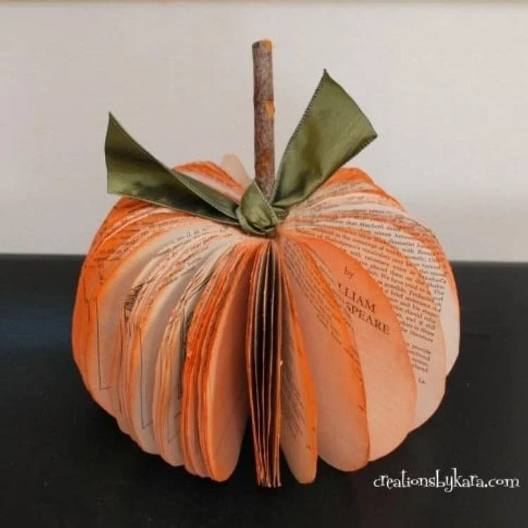 Paper pumpkin made out of folded book papers.