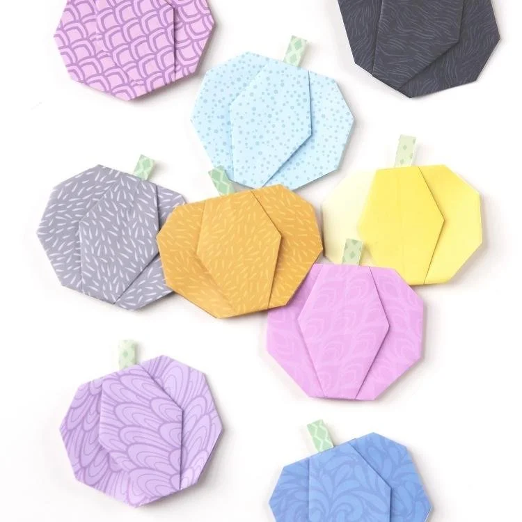 Flat origami pastel pumpkins.