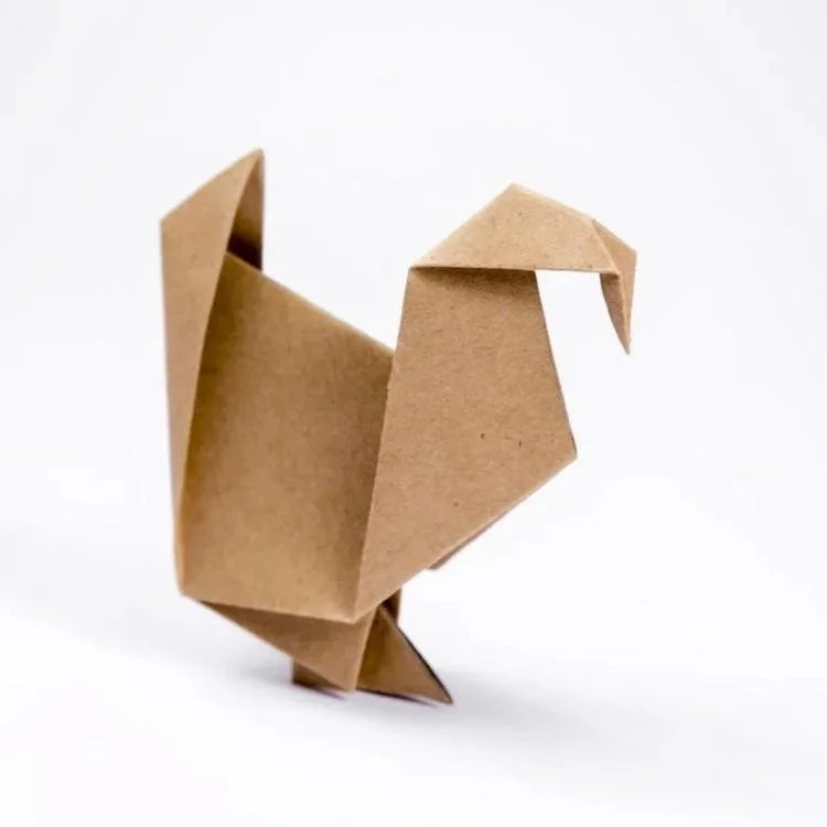 Origami turkey made from brown paper.