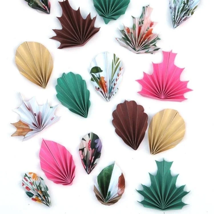 Paper origami leaves on white background.