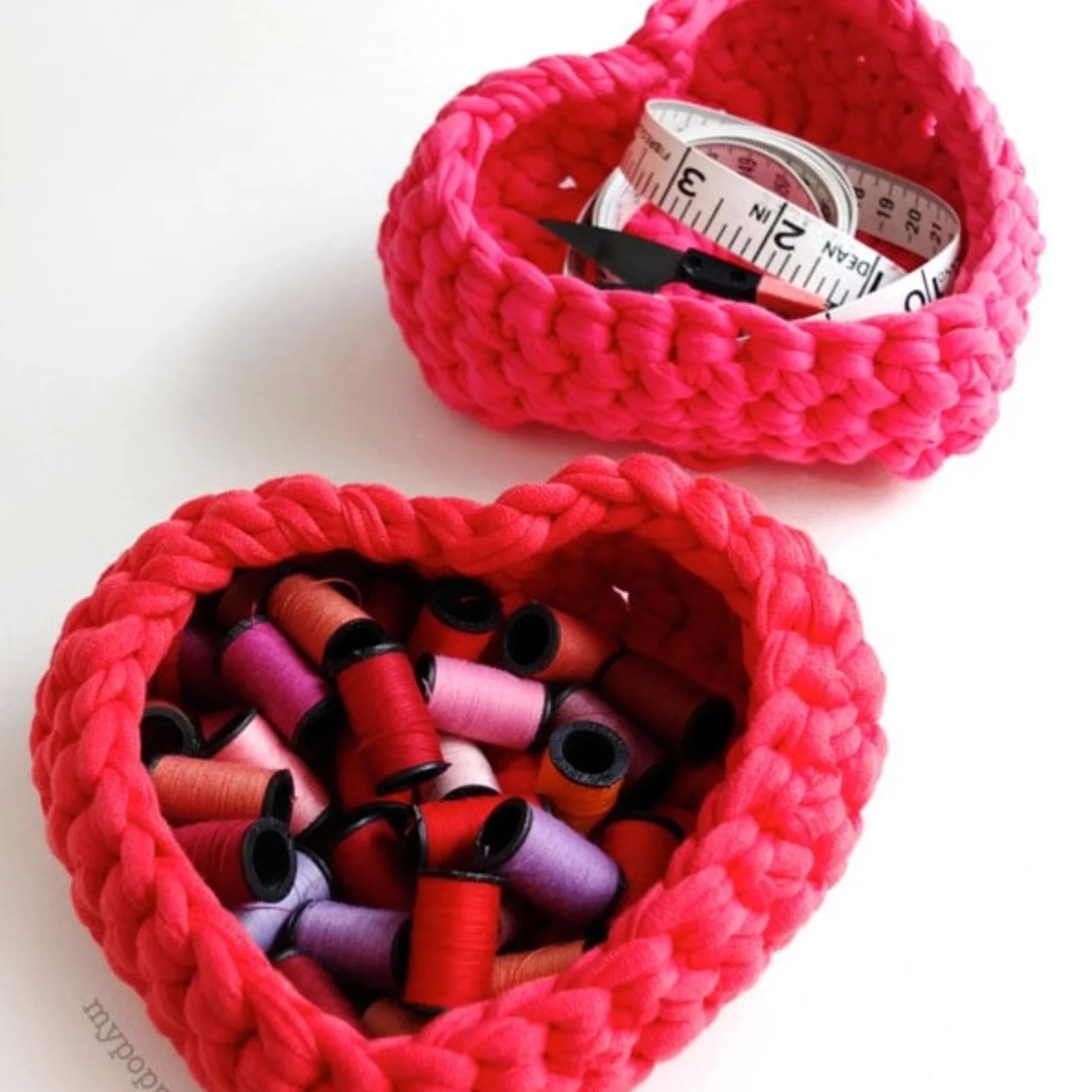 Heart shaped crochet baskets filled with sewing threads.