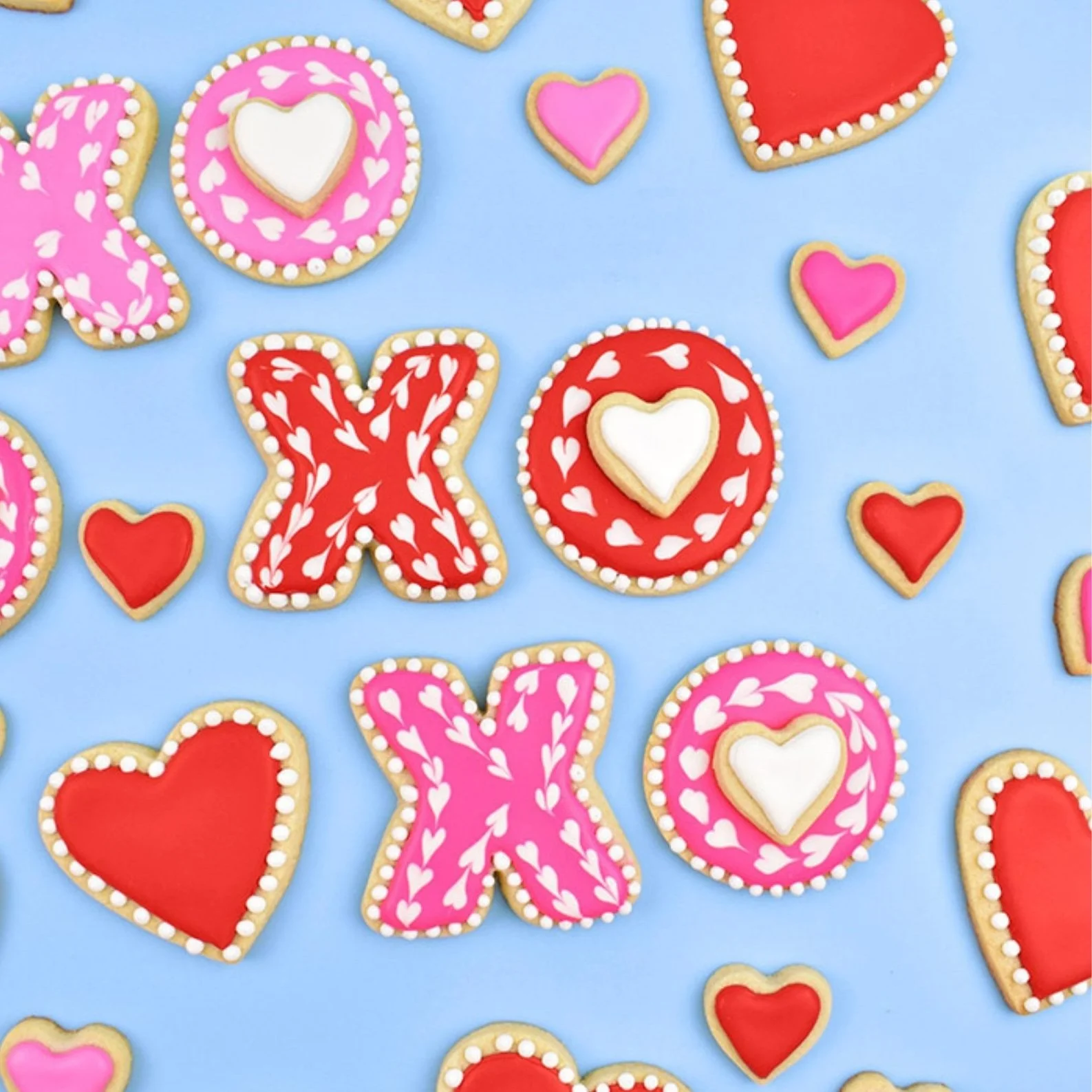 Decorated cookies in the shapes of hearts and x's and o's.