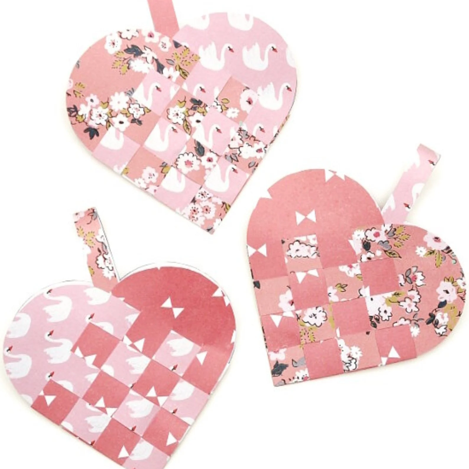 3 pink woven paper hearts.