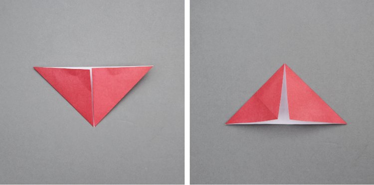 Red origami paper folded into a triangle shape.