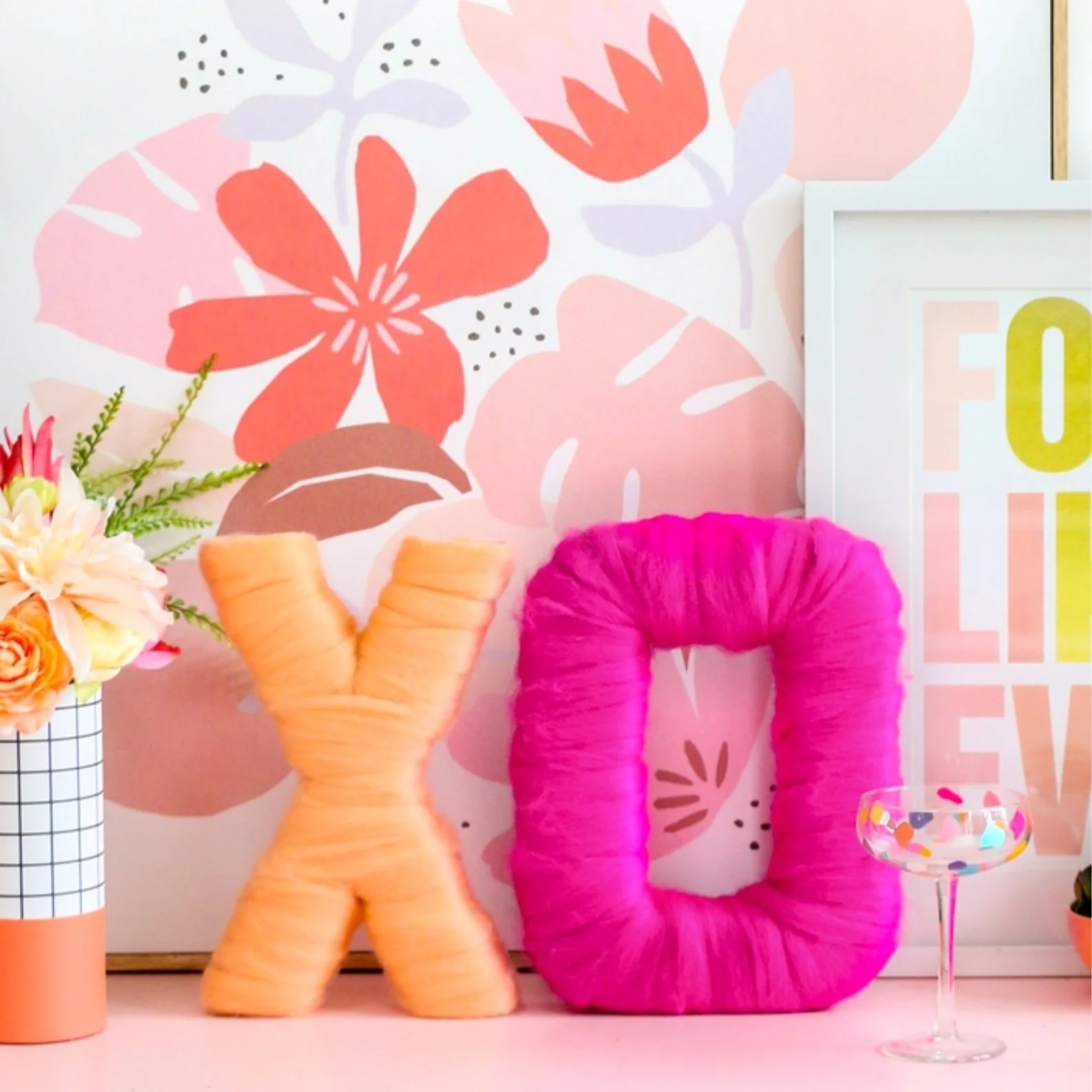 Wool wrapped letters in the shapes of x and o.