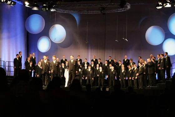 Derrek Wayne (center, soloists) sings the Ben Folds song "Still Fighting It" with The Westminster Chorus as they accept the 2010 International Chorus Championship of the Barbershop Harmony Society. 