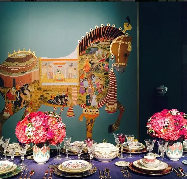 Always sublime, always elegant, the Hermès’s table, under an ornate equine decoration, featured the brand’s new tableware line, Voyage en Ikat. Image via Jessica Gordon Ryan.