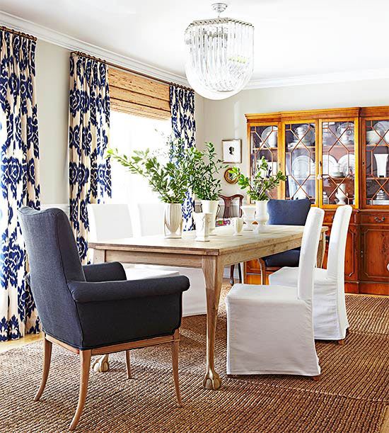 Blue and white paired with natural woods, a sisal rug create a comfortable and casual dining area. Image via Better Homes and Gardens