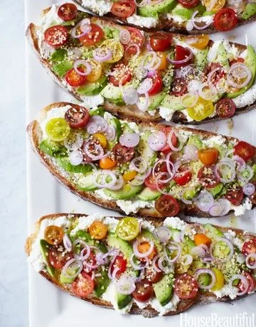 This vegetarian sandwich from chef Gabrielle Hamilton for House Beautiful is a perfect bite on a warm summer day.... heirloom tomatoes, onions, ricotta, lemon avocados and a hearty bread... It doesn't get more simple than that!