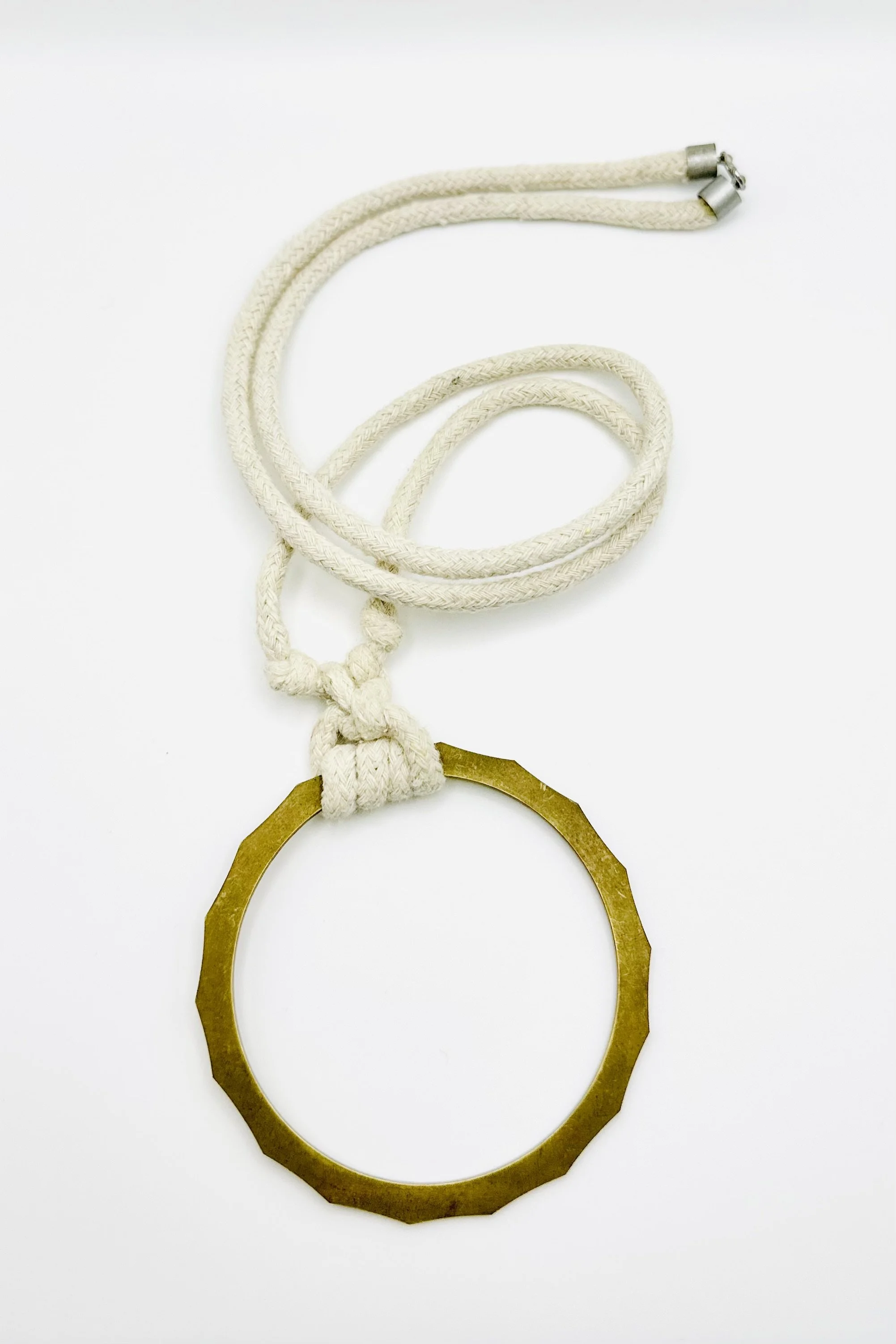 brass cog ring on natural rope